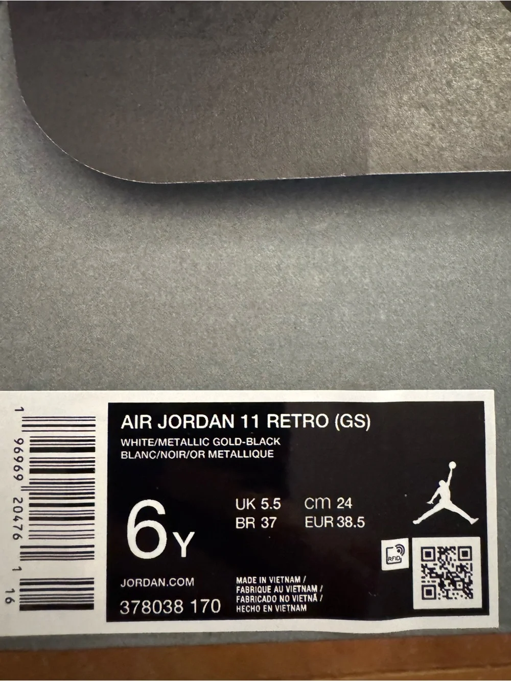 Air Jordan 11 Retro (GS) Big Kid’s Sneakers in White and Patent Black
